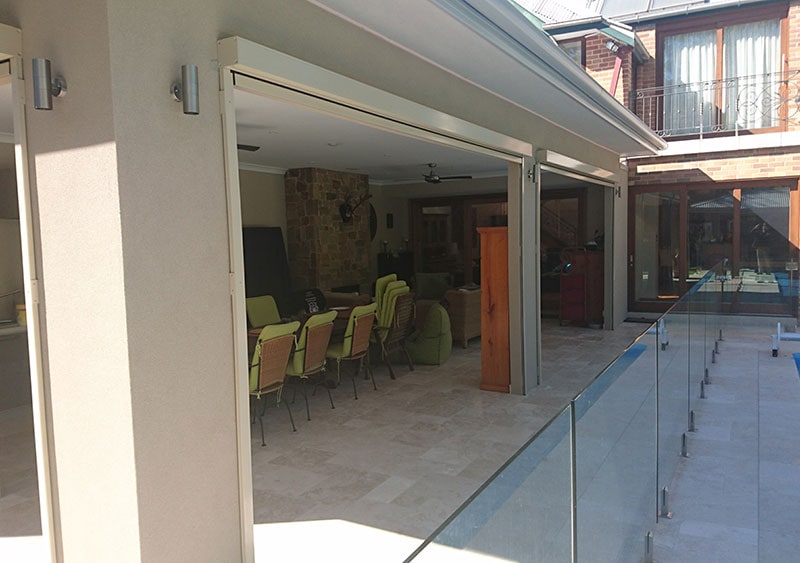 A home's rear view with all of the roller blinds up