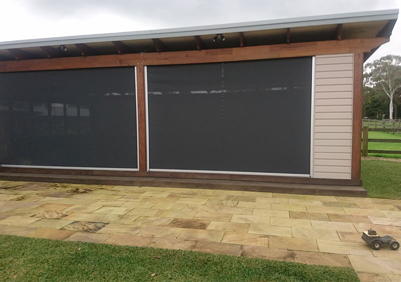 Covered shed with roller blinds