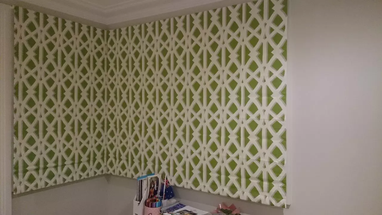 Green and white theme of roman blinds